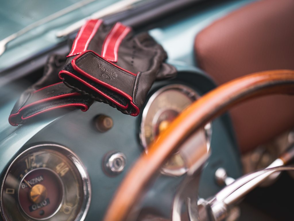 Pair of elegant premium black and red leather driving gloves, showcasing luxury craftsmanship by Gala Gloves
